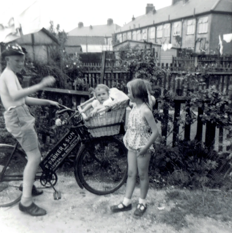 Peter in the back garden of the shop with his sister Ruth.